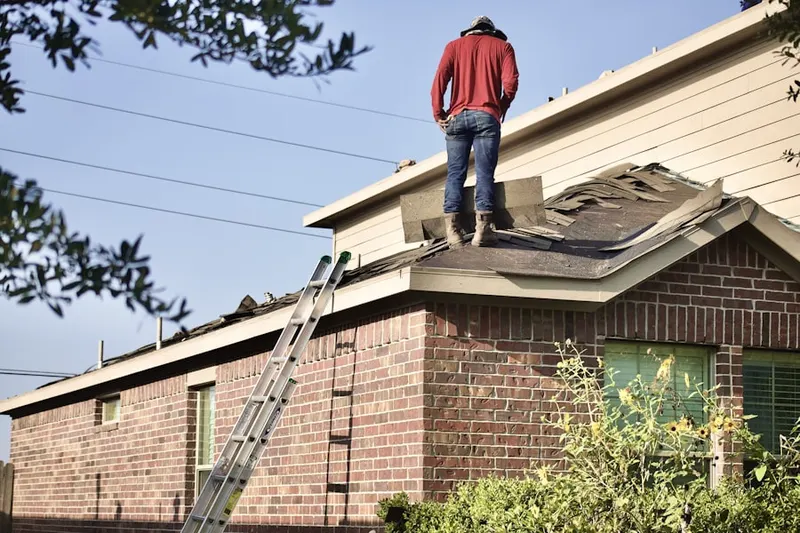Professional roofer working on a residential roof in Weatherly